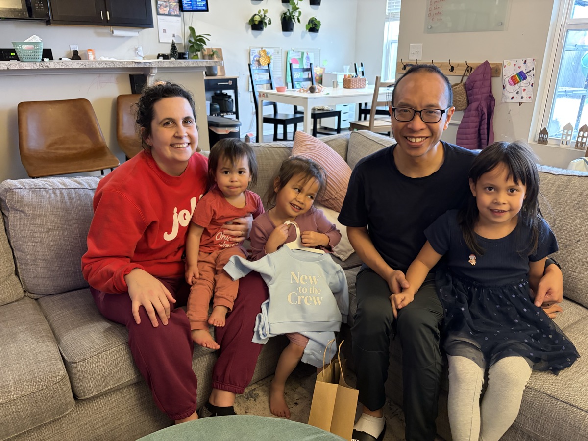 The Luk family — Dan, Maggie, and their three kids with number 4 on the wall